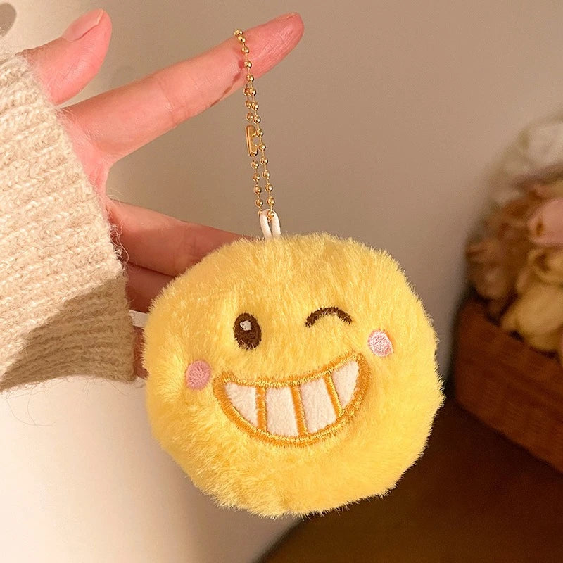 Kawaii-Faces smile emoji plush pendant shown next to everyday bag for size reference