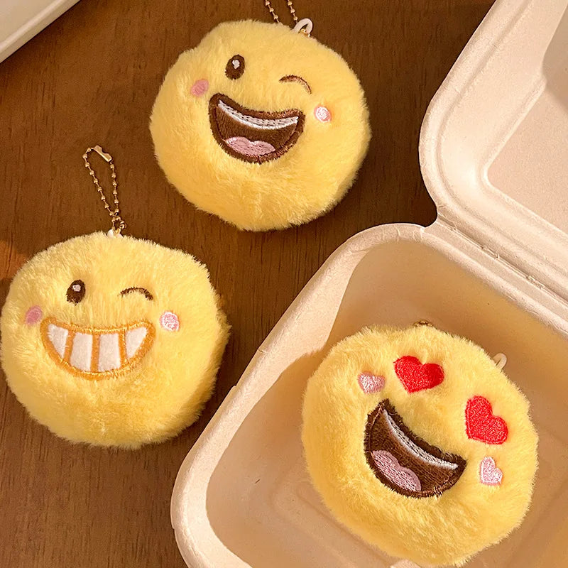 Smile emoji plush pendant variant B showing colorway detail and loop attachment hardware