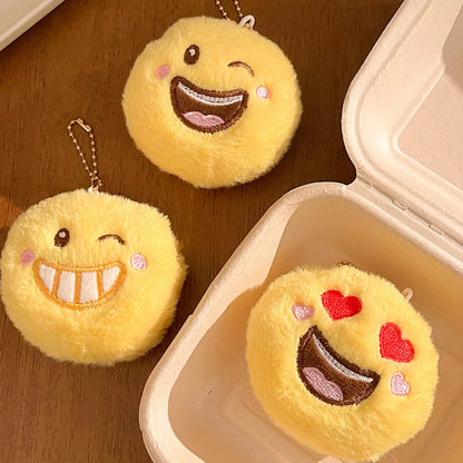 Smile emoji plush pendant variant B showing colorway detail and loop attachment hardware