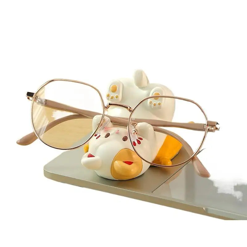 Cute cartoon cat desk ornament with glasses resting in figurine arms