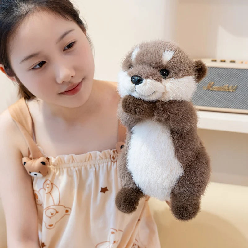 Kawaii otter stuffed animal lying on back showing soft cream belly fabric and tail stitching