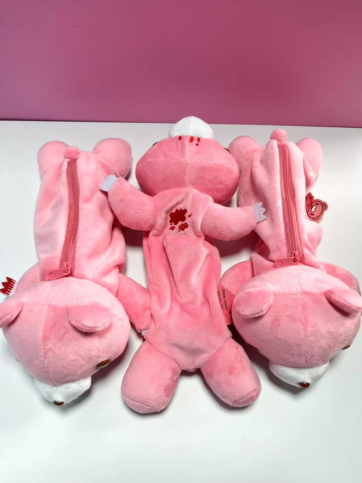 Kawaii bear zipper pouch flat lay, blush pink plush, full-width zipper visible