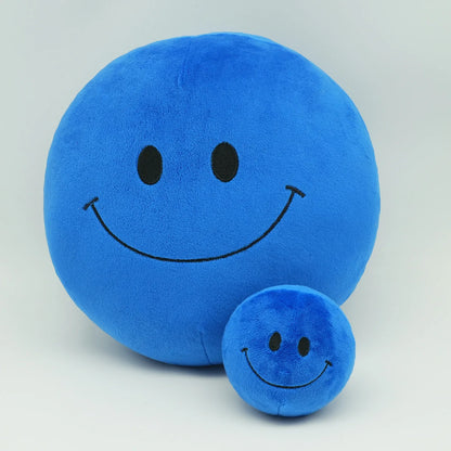 Yellow kawaii smiley plush ball displayed on a pastel shelf as room decor