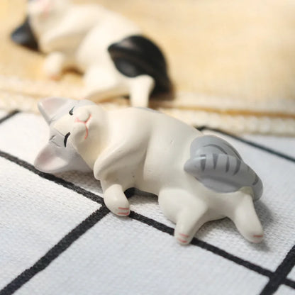 Six kawaii neko miniature statues displayed on a wooden dollhouse shelf