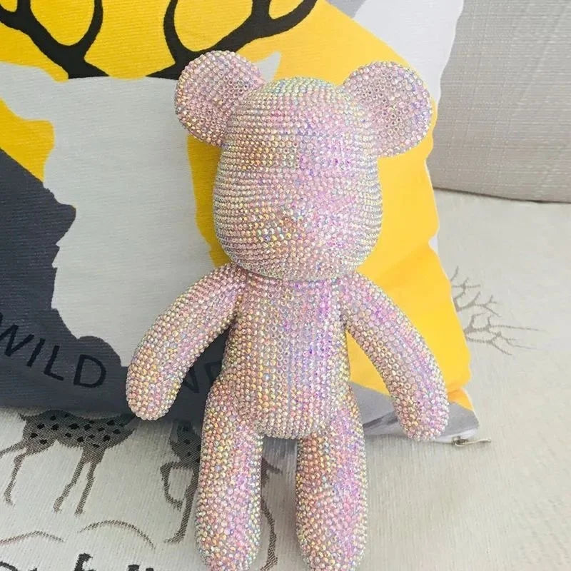 Black rhinestone kawaii bear figurine catching light from multiple angles on desk