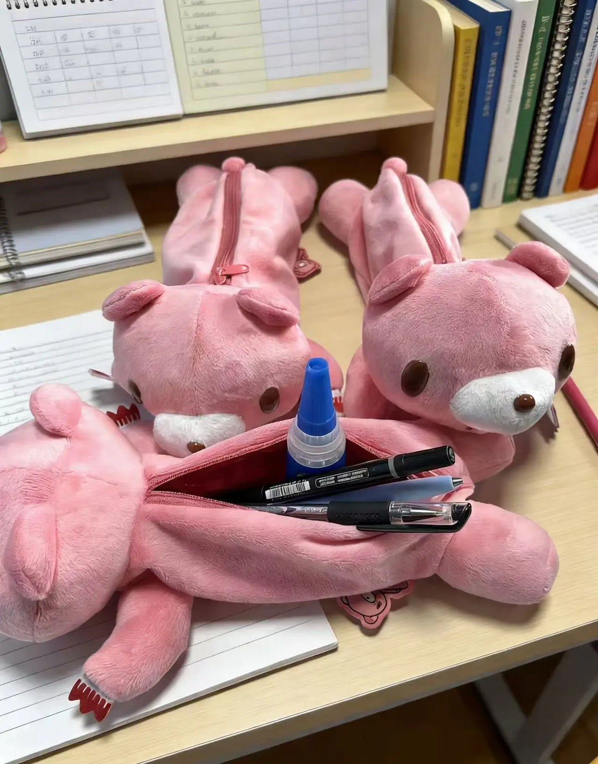 Y2K kawaii pink bear plush pencil case front view on desk, zipper closed