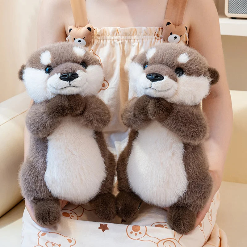 Close-up of kawaii otter plush face showing embroidered round eyes and stitched whisker detail