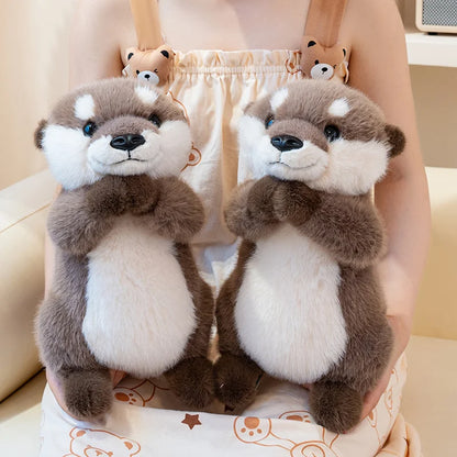 Close-up of kawaii otter plush face showing embroidered round eyes and stitched whisker detail