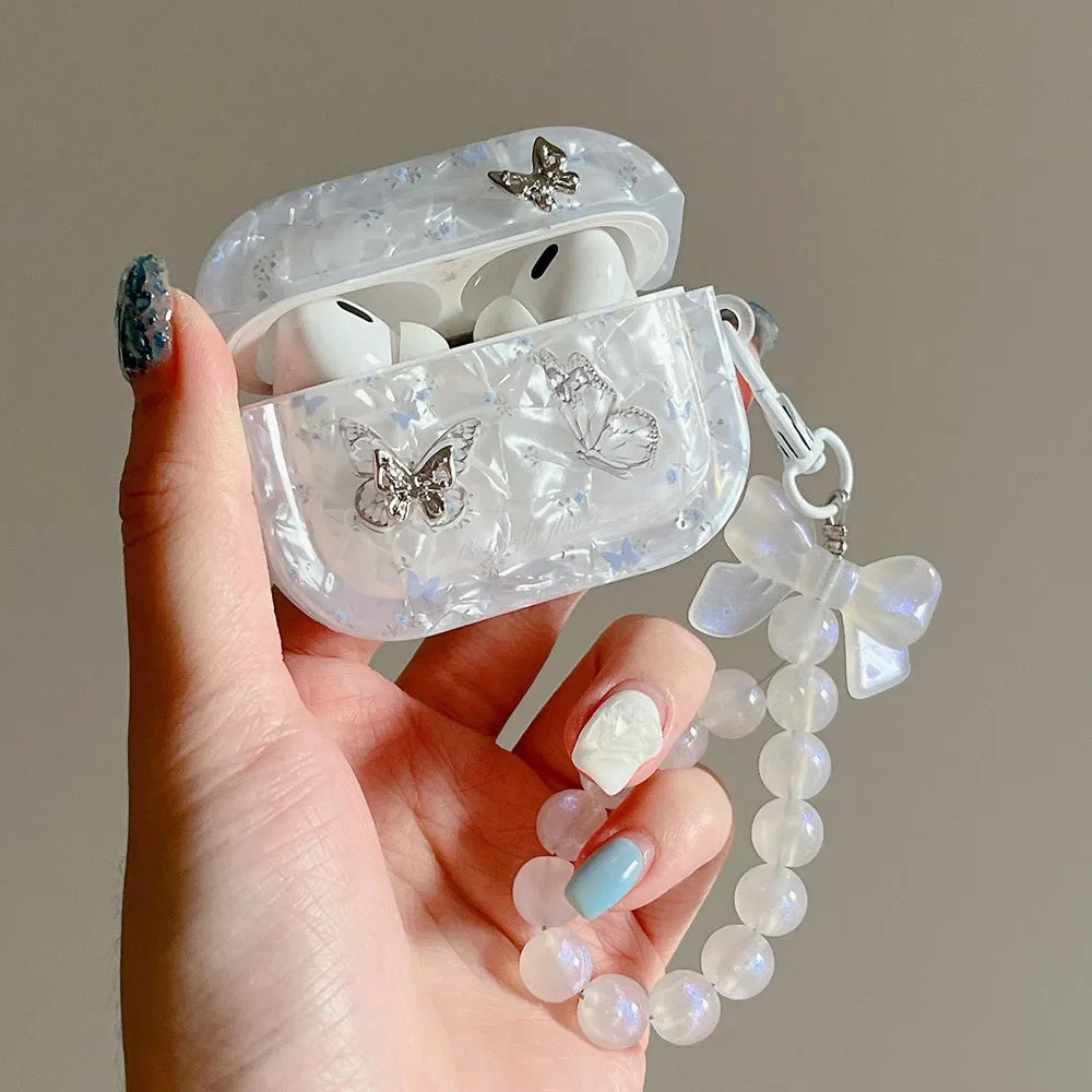 Shell texture butterfly AirPods case with dangling pendant charm, side angle view