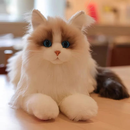 Soft simulation cat doll lying in relaxed floppy pose on white surface
