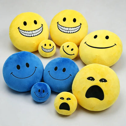 Kawaii smiley face plush ball in warm yellow, front view showing embroidered smile