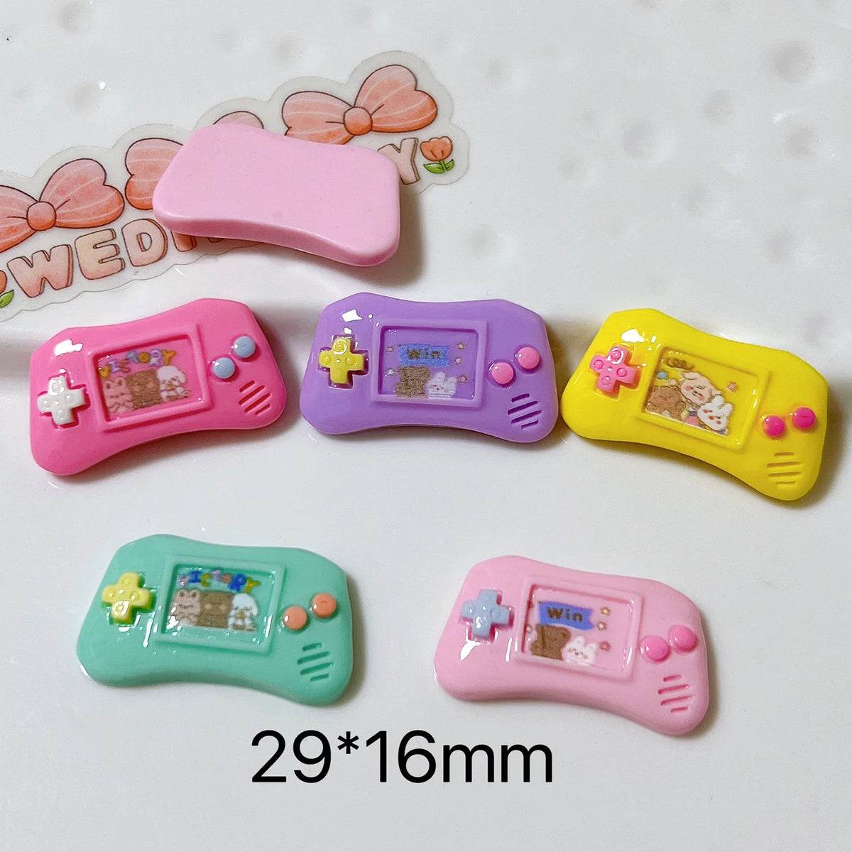 Kawaii resin game console cabochons close-up showing flat back surface