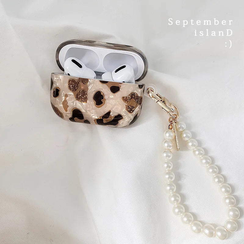 Kawaii-Faces leopard AirPods case worn with Harajuku accessories flat lay