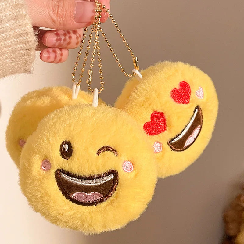 Plush smiley face keychain charm variant C with soft fabric texture visible up close