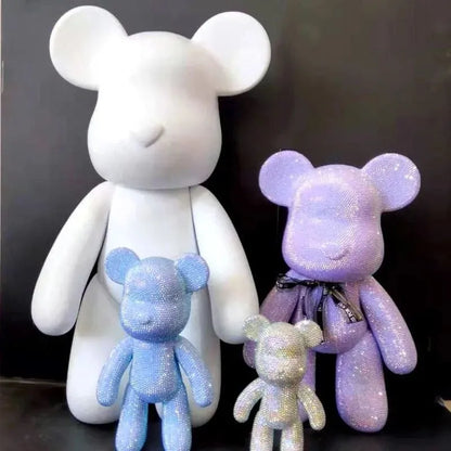 Close-up of faceted rhinestones being pressed onto kawaii bear sculpture with applicator tool
