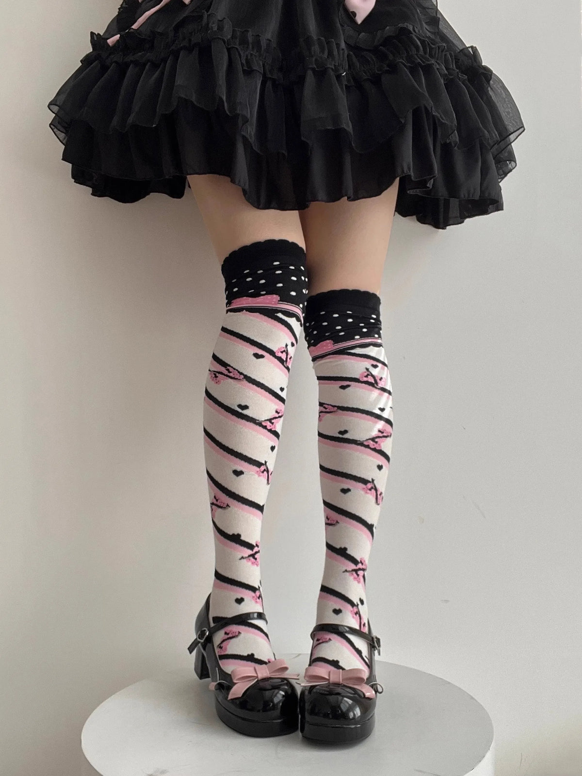 Kawaii polka dot stockings close-up showing over-the-knee cuff and dot pattern scale