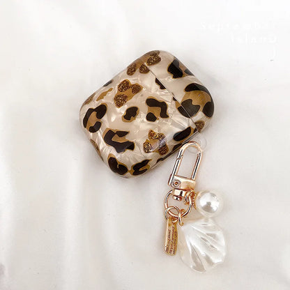 Three kawaii leopard AirPods case variants: pearl, shell, and heart
