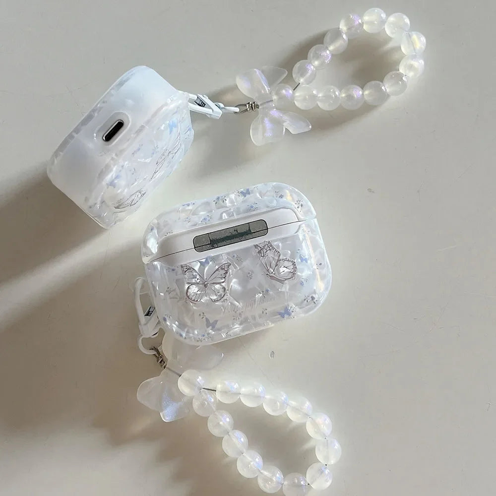 Butterfly AirPods case showing molded shell texture detail and metal butterfly accent close-up