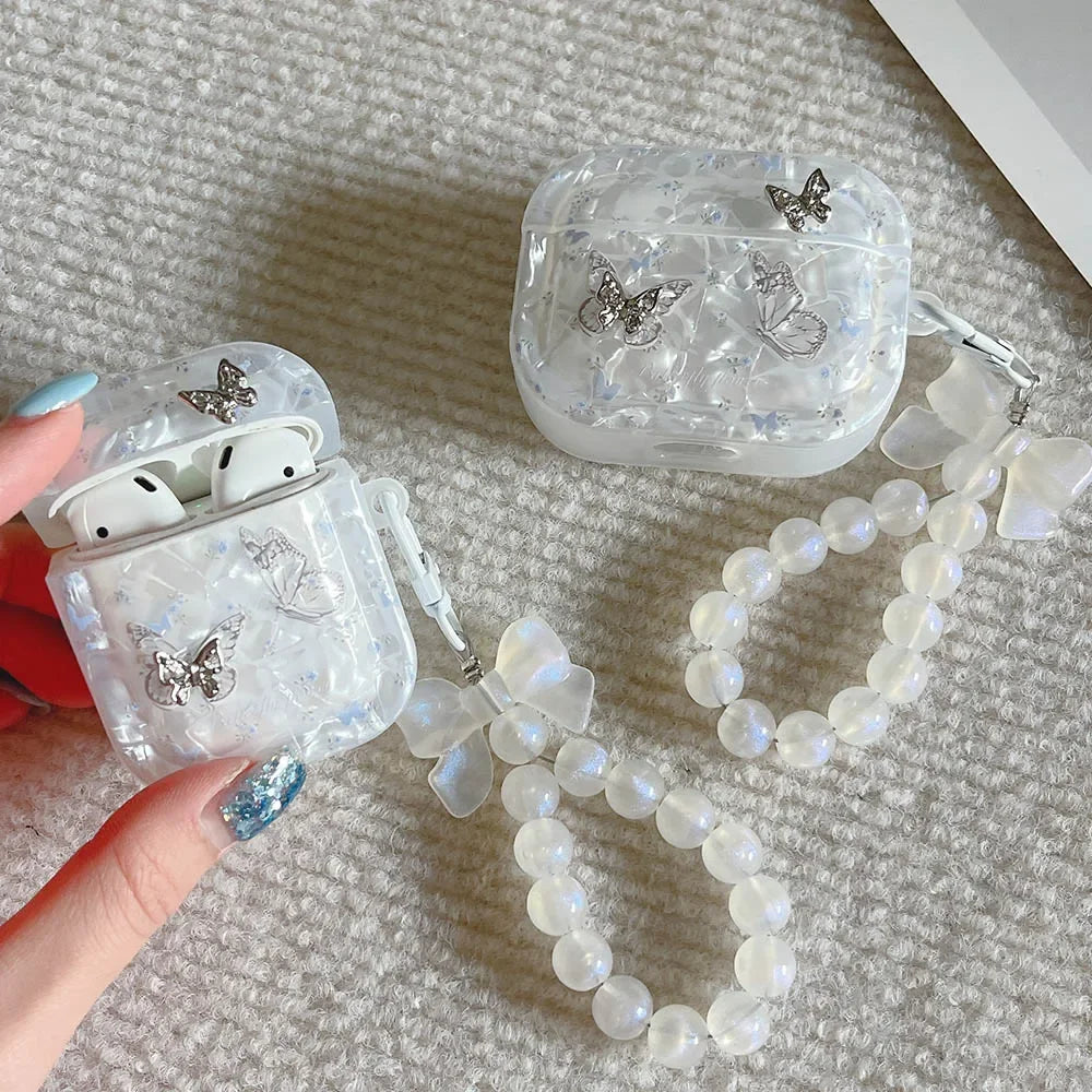 Kawaii butterfly metal AirPods case with shell texture finish and pendant loop, front view