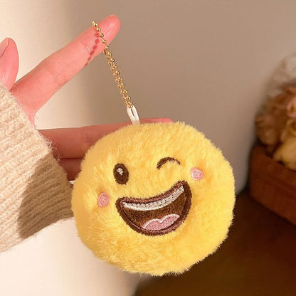 Kawaii smile emoji plush bag charm pendant hanging from a backpack zipper pull in use