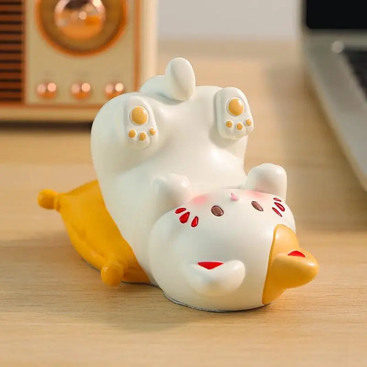 Kawaii cat phone stand resin figurine holding smartphone on white desk