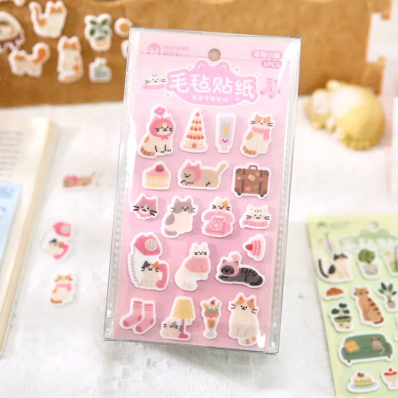 Kawaii cat felt stickers applied to journal spread alongside washi tape and handwriting