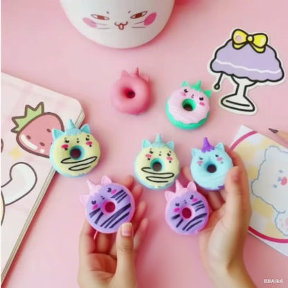 Kawaii unicorn eraser set arranged on white desk, pastel mint and lavender tones